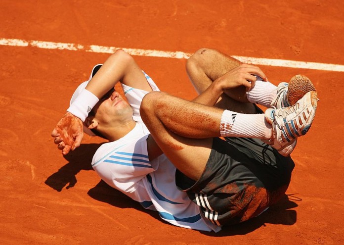 PARIS - JUNE 07: Novak Djokovic of Serbia and Montenegro grimaces on the clay against Rafael Nadal of Spain during day eleven of the French Open at Roland Garros on June 7, 2006 in Paris, France. (Photo by Clive Brunskill/Getty Images)