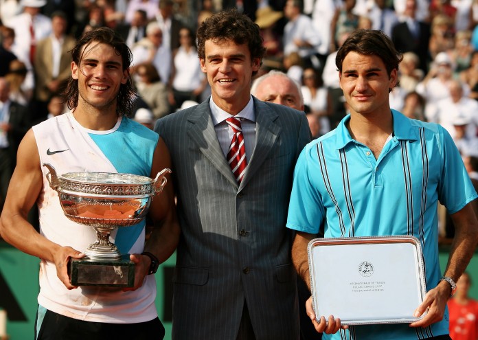 PARIS - JUNE 10: Rafael Nadal (L) of Spain poses with the Philippe Chatrier Trophy after winning against Roger Federer (R) of Switzerland and former winner Gustavo Kuerten (C) after the Men's Singles Final on day fifteen of the French Open at Roland Garros on June 10, 2007 in Paris, France. (Photo by Clive Brunskill/Getty Images)