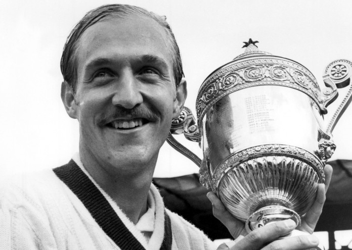 Stan Smith (USA) holds up the Gentlemen's Singles trophy on Centre Court after winning the final against Llie Nastase (ROM) at The Championships 1972. Held at The All England Lawn Tennis Club, Wimbledon. Credit: AELTC/Michael Cole.
