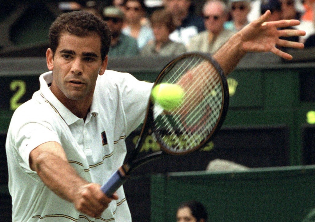 Defending champion Pete Sampras plays a backhand return to Australia's Scott Draper during their first round Men's Singles match on the Centre Court at Wimbledon, Monday June 21, 1999. Sampras won the match 6-3, 6-4, 6-4.(AP Photo/Dave Caulkin)