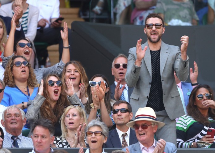 LONDON, ENGLAND - JULY 10: Justin Timberlake applauds a shot played by Serena Williams of the United States during her Ladies' Singles Quarter-Finals match against Camila Giorgi of Italy on day eight of the Wimbledon Lawn Tennis Championships at All England Lawn Tennis and Croquet Club on July 10, 2018 in London, England. (Photo by Michael Steele/Getty Images)