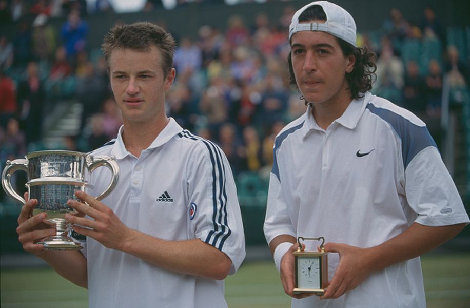Todd Reid of Australia (left) holds the trophy after defeating Lamine Ouahab of Algeria (right) in the final of the boy's singles tennis tournament at the Wimbledon Lawn Tennis Championships at the All England Lawn Tennis Club in Wimbledon, London in July 2002. (Photo by Professional Sport/Popperfoto/Getty Images)