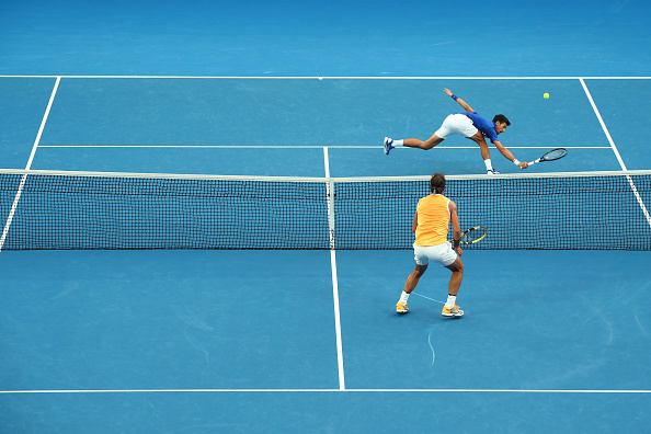 MELBOURNE, AUSTRALIA - JANUARY 27: Novak Djokovic of Serbia plays a backhand in his Men's Singles Final match against Rafael Nadal of Spain during day 14 of the 2019 Australian Open at Melbourne Park on January 27, 2019 in Melbourne, Australia. (Photo by Scott Barbour/Getty Images)