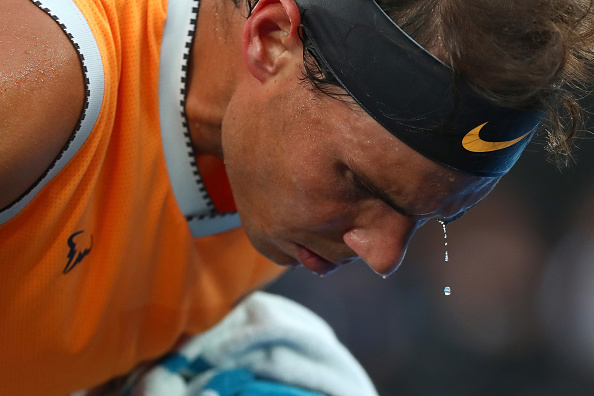 MELBOURNE, AUSTRALIA - JANUARY 27: Droplets of sweat are seen fall from Rafael Nadal of Spain during a change of ends in his Men's Singles Final match against Novak Djokovic of Serbia during day 14 of the 2019 Australian Open at Melbourne Park on January 27, 2019 in Melbourne, Australia. (Photo by Michael Dodge/Getty Images)