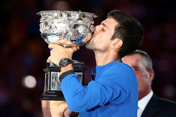 MELBOURNE, AUSTRALIA - JANUARY 27: Novak Djokovic of Serbia kisses the Norman Brookes Challenge Cup following victory in his Men's Singles Final match against Rafael Nadal of Spain during day 14 of the 2019 Australian Open at Melbourne Park on January 27, 2019 in Melbourne, Australia. (Photo by Cameron Spencer/Getty Images)