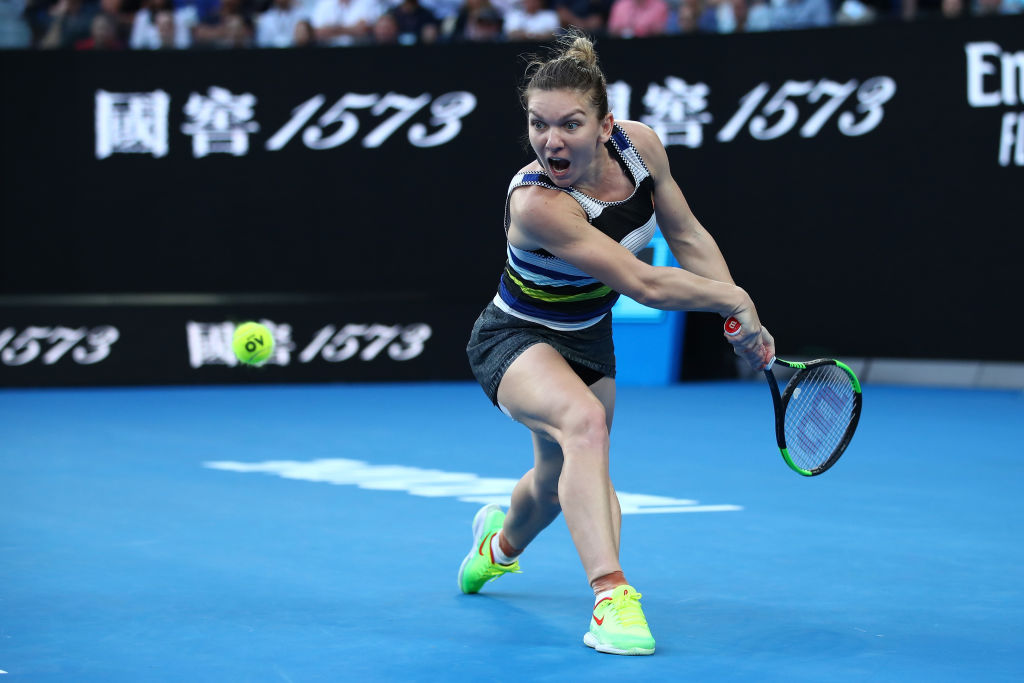 MELBOURNE, AUSTRALIA - JANUARY 21: Simona Halep of Romania plays a backhand in her fourth round match against Serena Williams of the United States during day eight of the 2019 Australian Open at Melbourne Park on January 21, 2019 in Melbourne, Australia. (Photo by Cameron Spencer/Getty Images)