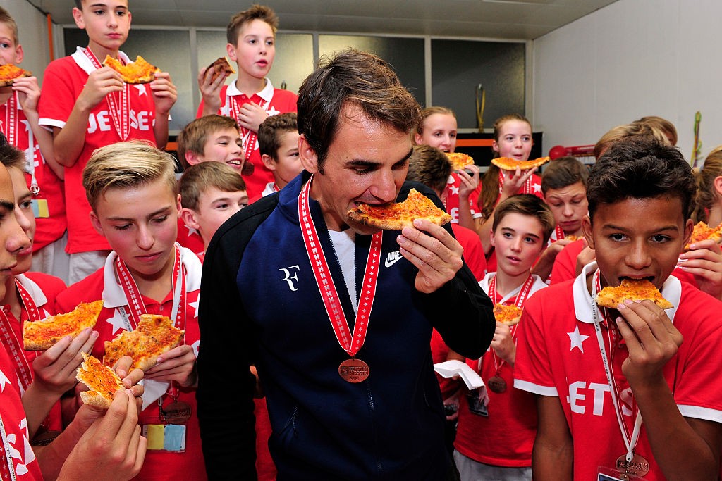BASEL, SWITZERLAND - NOVEMBER 01: Roger Federer (C) of Switzerland hands out pizza as he celebrates with the ball boys winning the final match of the Swiss Indoors ATP 500 tennis tournament against Rafael Nadal of Spain at St Jakobshalle on November 1, 2015 in Basel, Switzerland (Photo by Harold Cunningham/Getty Images)