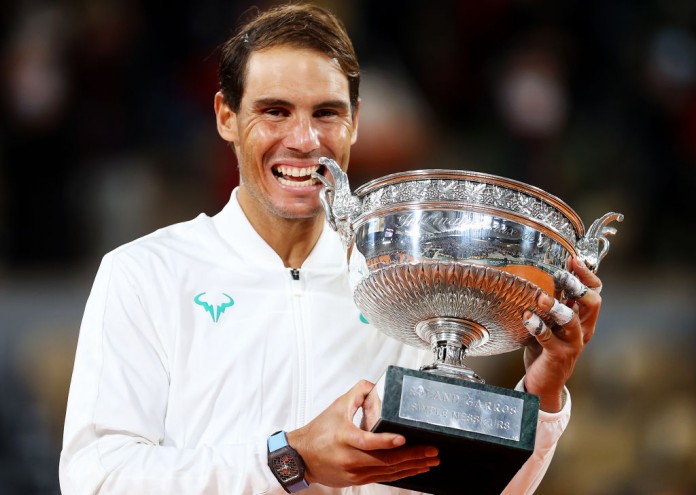PARIS, FRANCE - OCTOBER 11: Rafael Nadal of Spain bites the winners trophy following victory in his Men's Singles Final against Novak Djokovic of Serbia on day fifteen of the 2020 French Open at Roland Garros on October 11, 2020 in Paris, France. (Photo by Julian Finney/Getty Images)