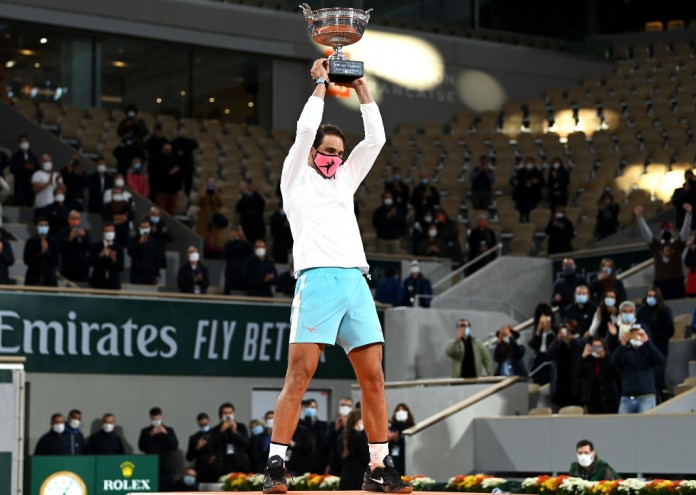 PARIS, FRANCE - OCTOBER 11: Rafael Nadal of Spain lifts the winners trophy following victory in his Men's Singles Final against Novak Djokovic of Serbia on day fifteen of the 2020 French Open at Roland Garros on October 11, 2020 in Paris, France. (Photo by Shaun Botterill/Getty Images)