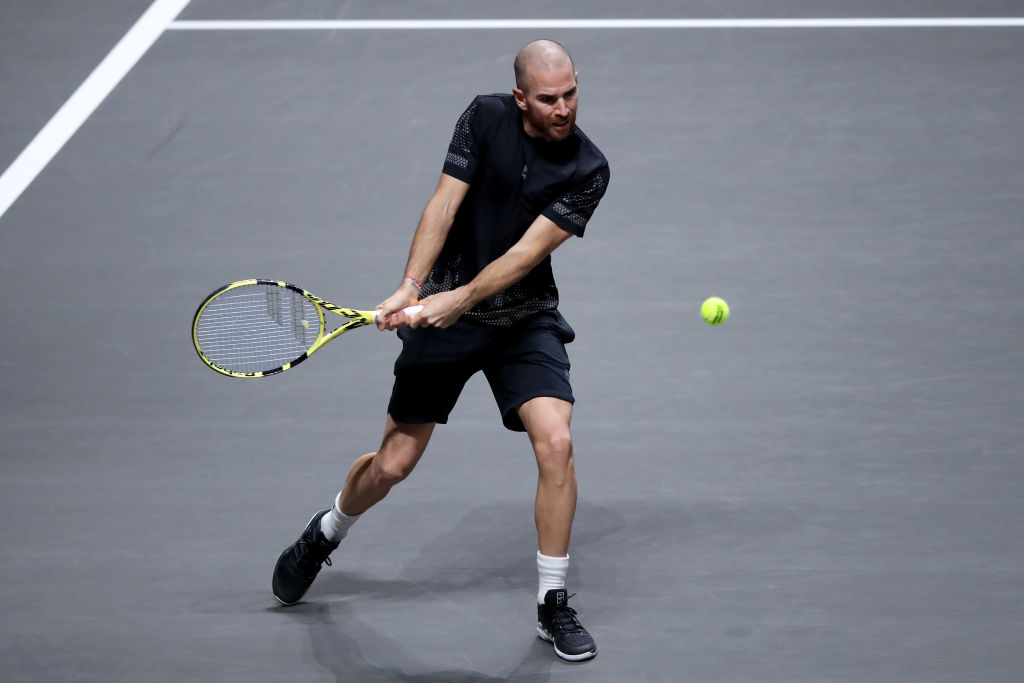 COLOGNE, GERMANY - OCTOBER 23: Adrian Mannarino of France plays a backhand during the match between Alexander Zverev of Germany and Adrian Mannarino of France of day five of the Bett1Hulks Championship Tennis Tournament at Lanxess Arena on October 23, 2020 in Cologne, Germany. (Photo by Christof Koepsel/Getty Images)