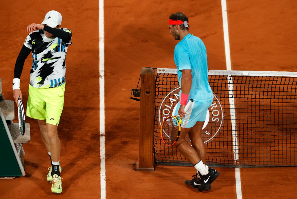 PARIS, FRANCE - OCTOBER 06: Jannik Sinner of Italy (L) walks past Rafael Nadal of Spain as they switch ends during their Men's Singles quarterfinals match on day ten of the 2020 French Open at Roland Garros on October 06, 2020 in Paris, France. (Photo by Clive Brunskill/Getty Images)